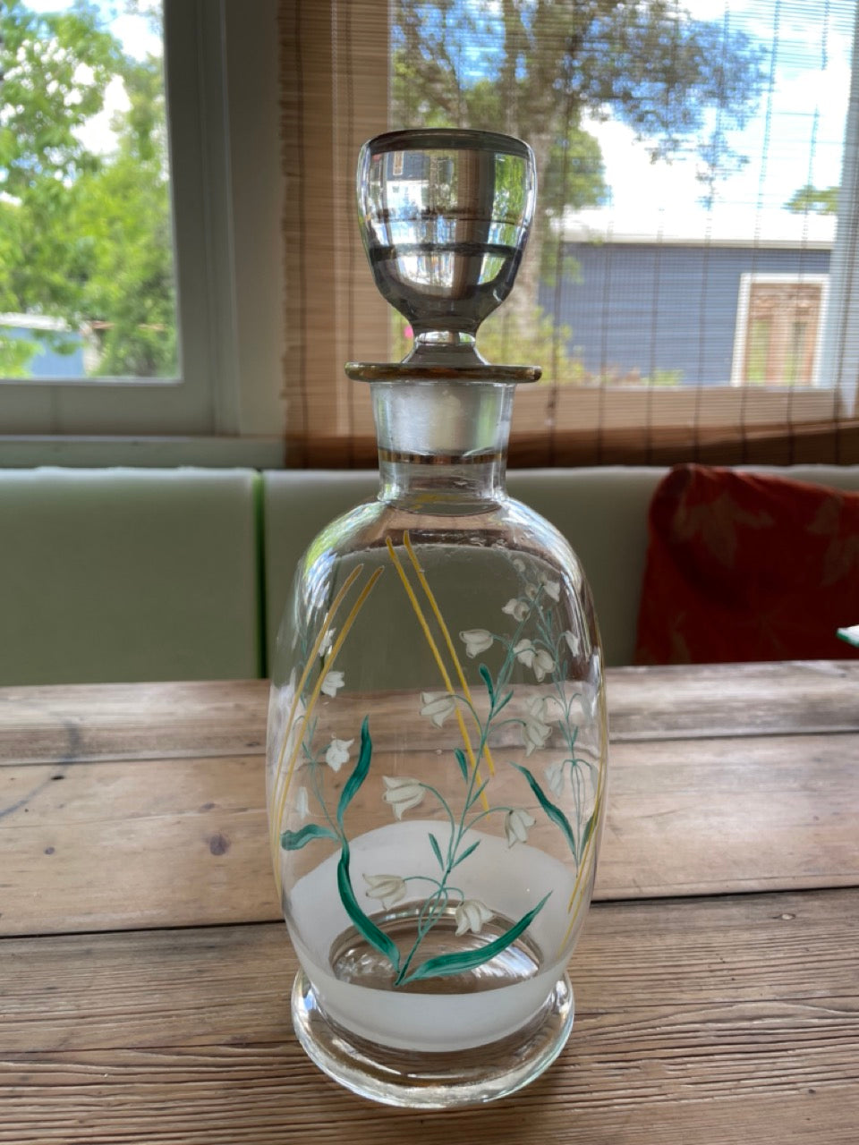 Vintage glass decanter with painted flowers
