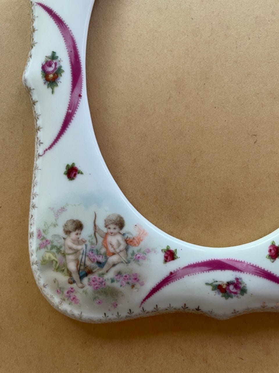 Antique porcelain frame with cherubs